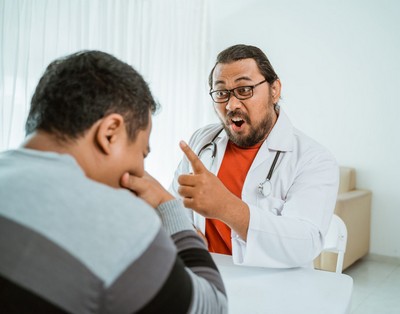 Doctor admonishing unwilling patient